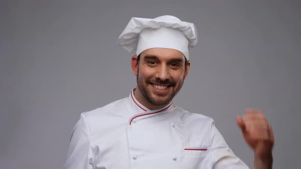 Happy Smiling Male Chef Adjusting Toque