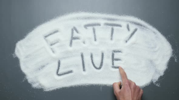 Fatty liver written on sugar background. Stop diabetes. Sugar and sweets kill.