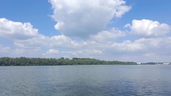 Slow motion 4k video of sunny day on the Danube river with beautiful clouds on the sky.