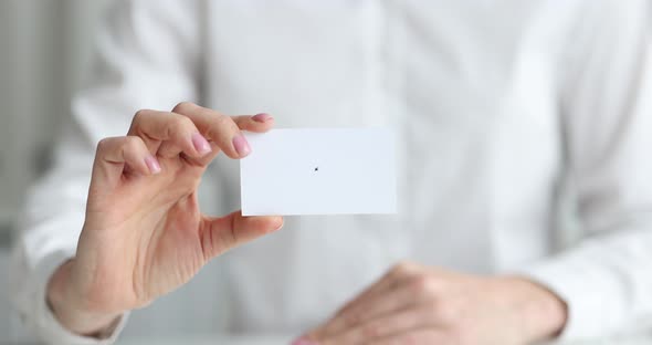 Person Passes White Business Card to Partner