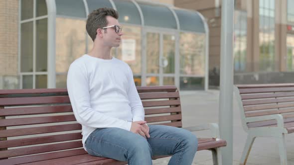 Young Man Standing and Leaving After Sitting on Bench Outdoor
