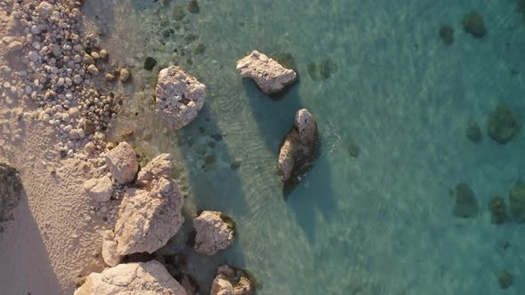 Aerial View of Tropical Beach with Crystal Clear Water and Stones