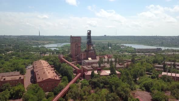 Mine railway and quarry red iron ore headframe aerial drone forward push in camera movement