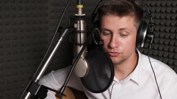 Young Musician That Is Recording New Song in a Sound Studio