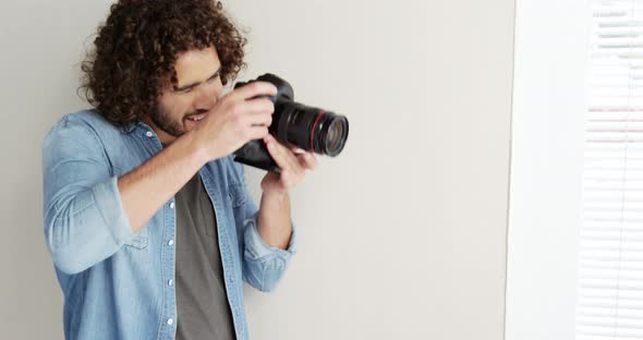 Photographer looking at photos on digital camera