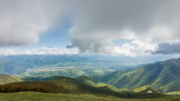 Clouds Moving over Green Alpine Mountains Landscape in Sunny Summer