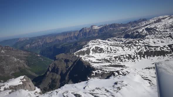 Aerial view over Switzerland. Beautiful, panoramic, snowy scenery. Flying over Swiss mountains on a