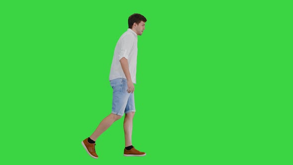 Exhausted Young Man Walking Touching His Shirt While Suffering From Summer Heat Green Screen Chroma