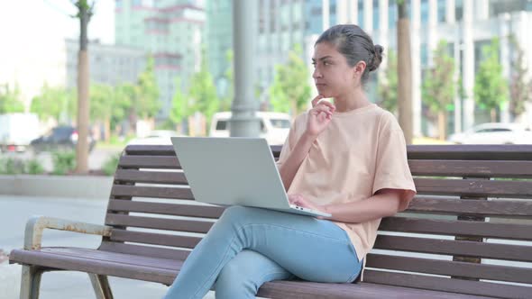 Indian Woman Thinking While Working on Laptop in Office