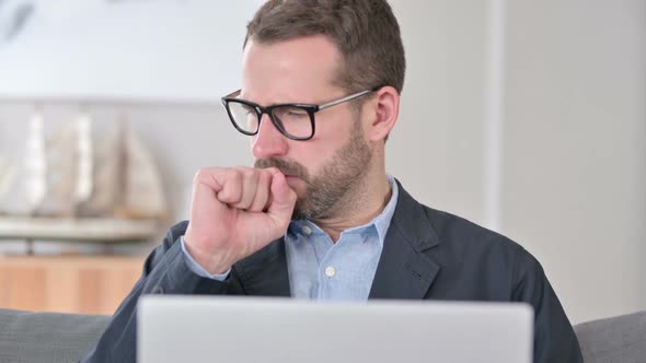 Close Up of Young Businessman with Laptop Coughing