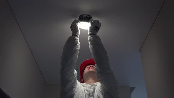 Young Worker Man Installing Led Lights on Ceiling Hole