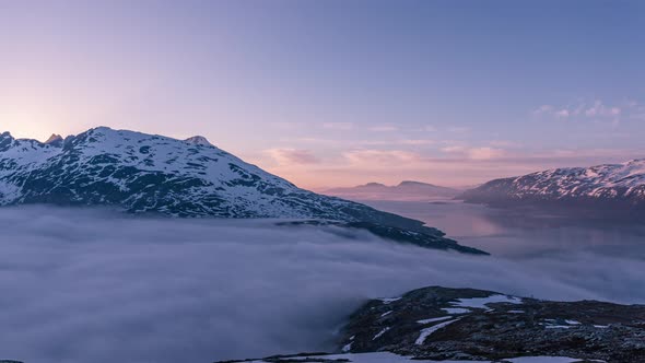 A time lapse of fog flowing from one fjord to another in northern Norway during midnight sun