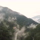 Aerial Drone Mountain Road Through Green Forest Valley with Trees and Rainy Fog - VideoHive Item for Sale