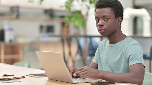 Thumbs Up By Positive Young African Man Working 