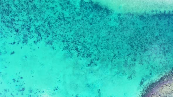Natural fly over abstract shot of a white sandy paradise beach and blue ocean background in colourfu