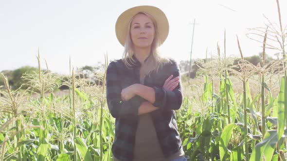 Video of happy caucasian woman standing in field on sunny day