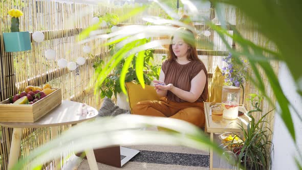 Young Woman Meditates on Sunny Terrace