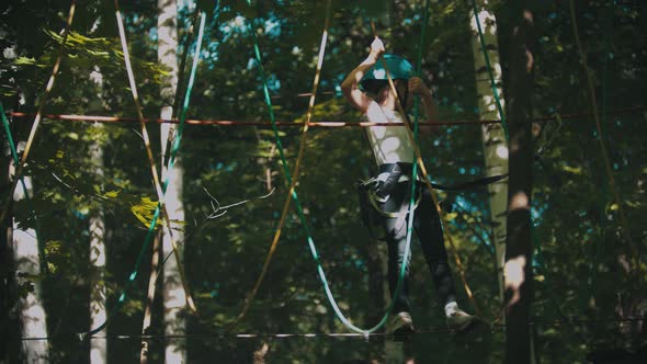 A Little Girl Walking on the Rope - an Entertainment Attraction in the Forest