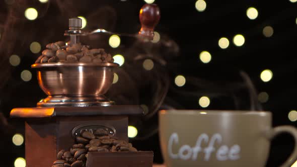 Coffee Grinder and Cup of Hot Coffee with a Smoke