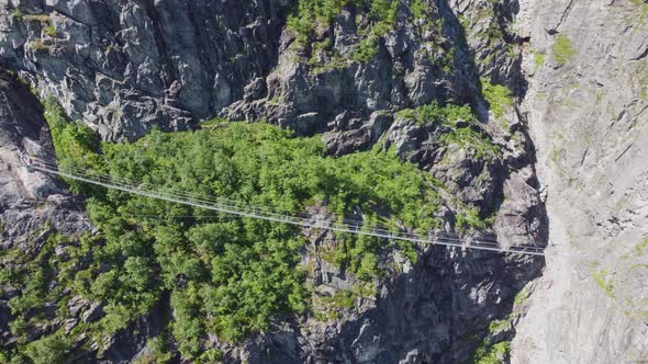Crazy spectacular bridge over gorge at Via Ferrata route to mountain Hoven in Loen Norway - Aerial