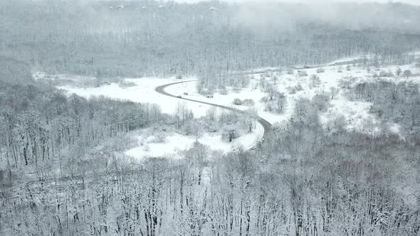 Drones Eye View  Winding Road From the High Mountain Pass in Winter