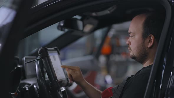 Mechanic Uses a Tablet Computer with an Augmented Reality Diagnostics Software