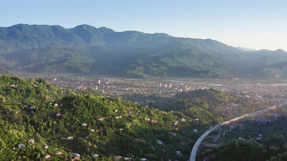 Aerial – Landscape Of Countryside And Valley Between Hills At Sunset