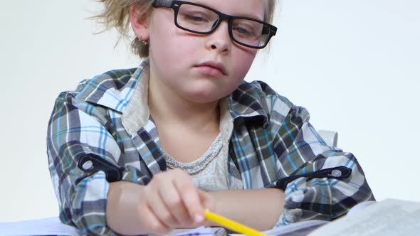 Tired Girl Reads the Book and Falls Asleep. White Background. Close Up