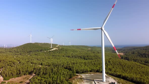 Aerial View Over the Farm Landscape and Wind Turbines Generating Clean Renewable Energy