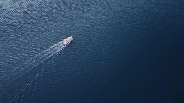 Motorboat is Swimming in the Sea on High Speed Leaving Foam Trails on Water Surface Filmed By Drone