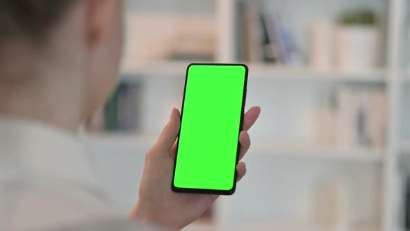Rear View of Woman Using Smartphone with Chroma Key Screen 