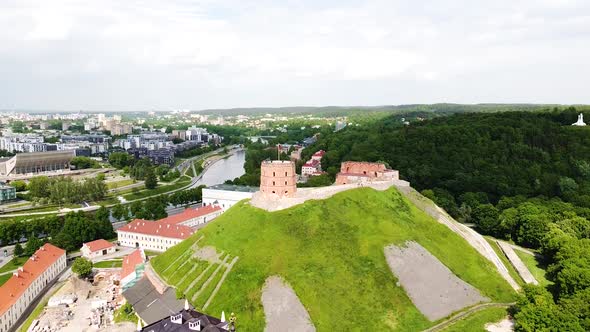 Gediminas castle on top of hill in Vilnius city center, aerial descend view