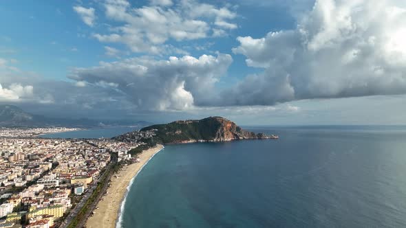 Aerial drone view of parachute jumper flying over beautiful Alanya