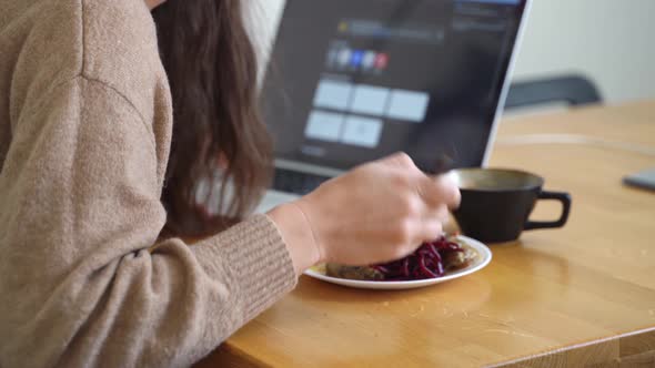 Close Up of Woman or Girl Eating and Working at the Same Time