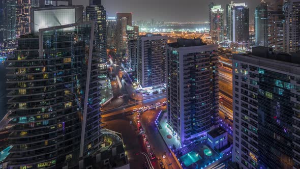 View of Various Skyscrapers and Towers in Dubai Marina From Above Aerial Night Timelapse