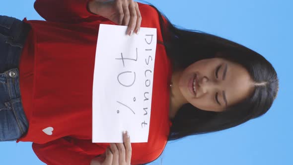 Young Woman Holding Discount Sign