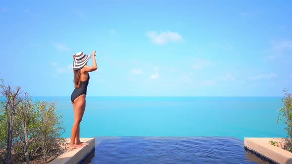 Young asian woman enjoy around outdoor swimming pool for leisure