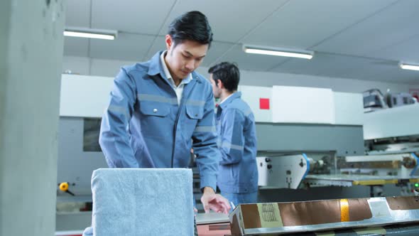 engineer team control and operate printing package lable machine with computer screen