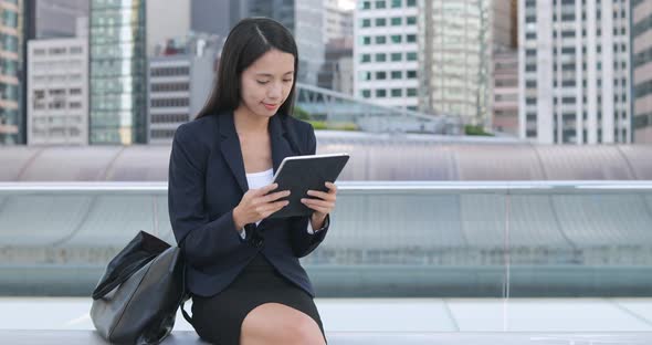 Business woman using digital tablet in the evening 