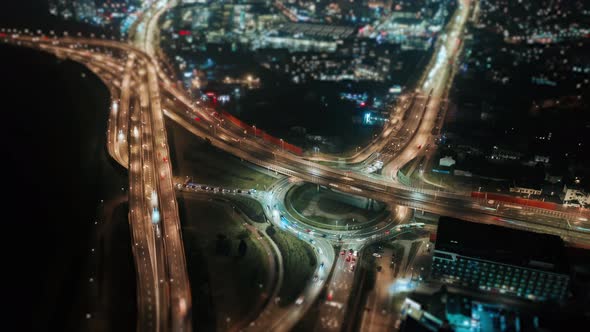 Aerial Drone Time Lapse Hyperlapse Car Traffic Roundabout Interchange Road at Night Top View