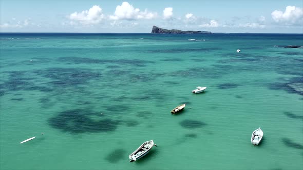 Steady panorama aerial shot of beautiful turquoise water and floating boats