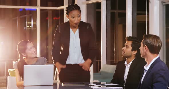 Businesswoman leading meeting in conference room