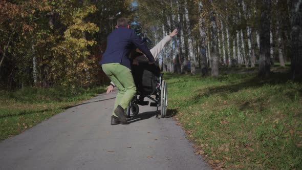 Disabled woman on wheelchair having fun with boyfriend