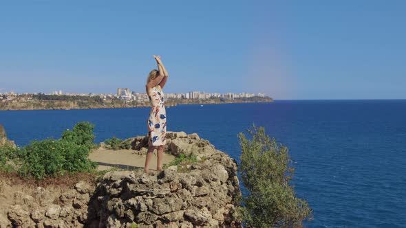 Adult Spiritful Woman Stands on the Rock By the Sea and Doing Spiritual Yoga Practices