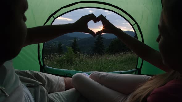 Couple in love resting in a tent in the mountains.