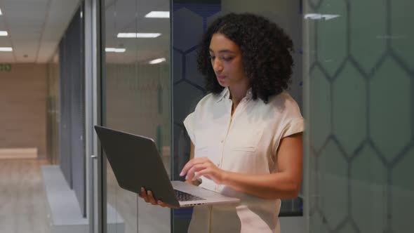 Businesswoman working on laptop in a modern office