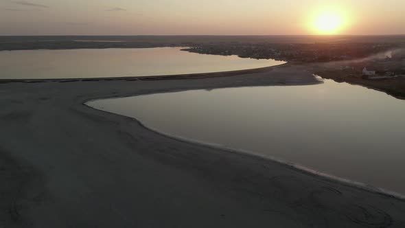 Two Seas Separated By the Coast on the Setting Yellowpink Sun Top View