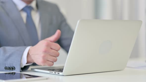 Close Up of Businessman Using Laptop Showing Thumbs Up