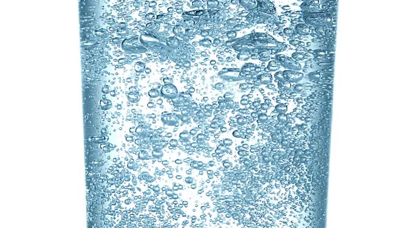 980005 Sparkling Water into Glass against White Background, Slow Motion