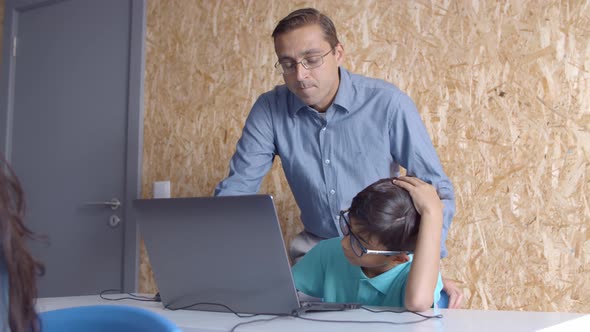 Computer Science Teacher Explaining Task To Schoolboy